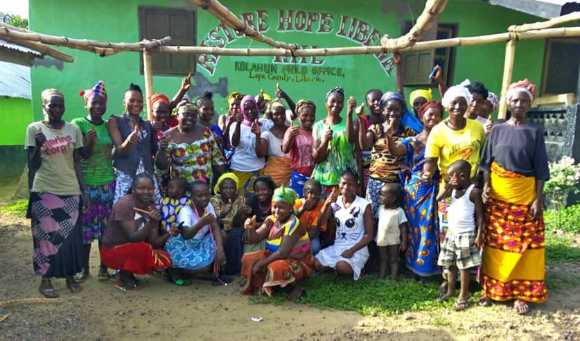  An image showing women from Liberian country-cloth weaving cooperative