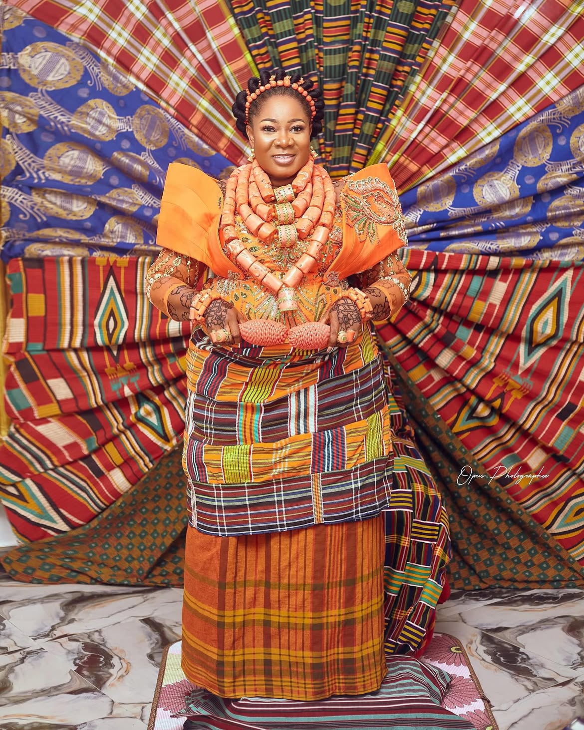 An image showing a woman wearing Ijaw and Kalabari Dress with layered coral beads.
