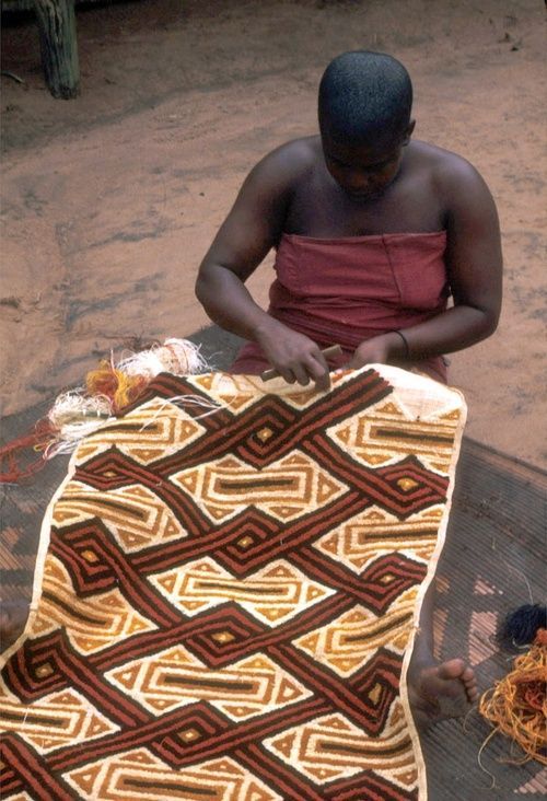Raffia palm fibres beside handwoven Kuba cloth from the Democratic Republic of Congo