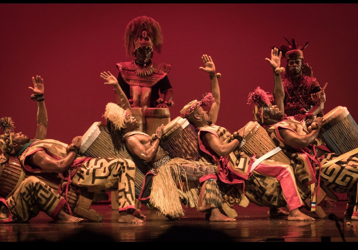Burundi Intore dancers performing at modern national ceremony with traditional regalia and official audience.