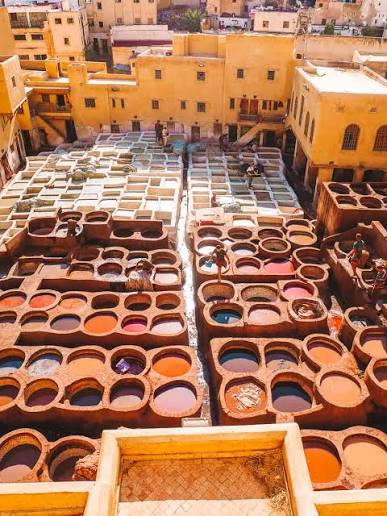 An image showing Chouara tannery Fes leather artisans, where Morocco's Babouche Leather Trade Begins