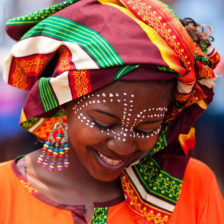 An image showing a lady wearing Mozambican capulana head wrap